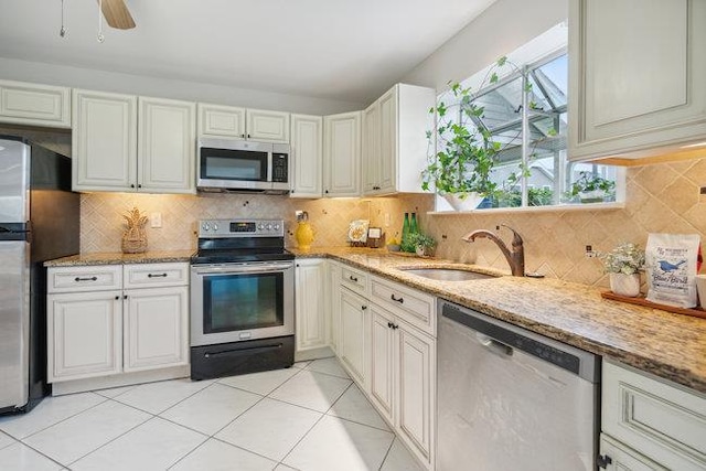 106 E Midland Pond Ct First Floor, First Floor, Moriches, NY 11955 - kitchen featuring appliances with stainless steel finishes, a sink, light stone counters, and tasteful backsplash