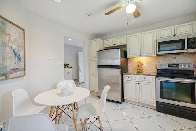 106 E Midland Pond Ct First Floor, First Floor, Moriches, NY 11955 - kitchen with stainless steel appliances, cream cabinets, decorative backsplash, light tile patterned floors, and ceiling fan