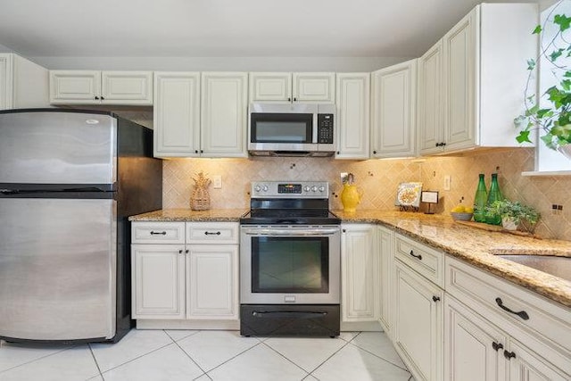 106 E Midland Pond Ct First Floor, First Floor, Moriches, NY 11955 - kitchen featuring stainless steel appliances, light stone counters, light tile patterned floors, and decorative backsplash
