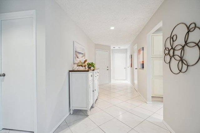106 E Midland Pond Ct First Floor, First Floor, Moriches, NY 11955 - corridor featuring a textured ceiling, light tile patterned floors, and baseboards