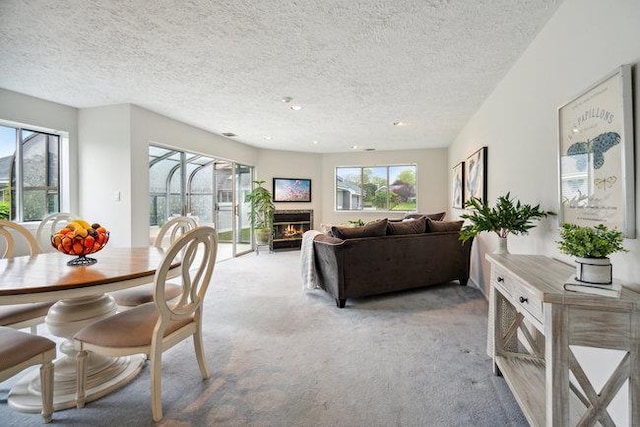 106 E Midland Pond Ct First Floor, First Floor, Moriches, NY 11955 - dining space featuring light colored carpet, a warm lit fireplace, a textured ceiling, and recessed lighting