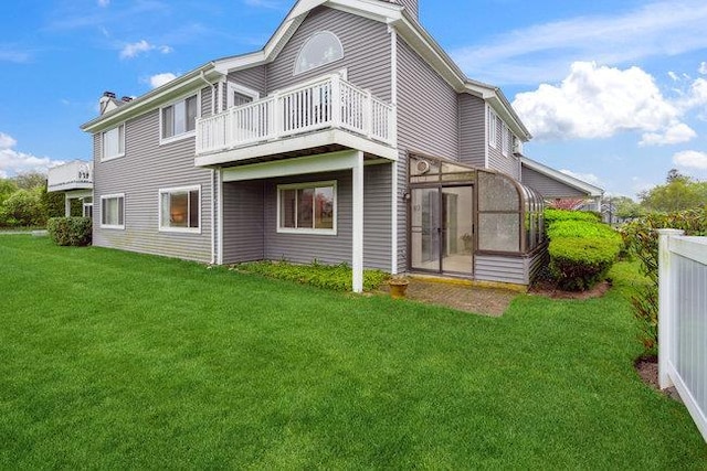 106 E Midland Pond Ct First Floor, First Floor, Moriches, NY 11955 - back of property with a chimney, a lawn, a balcony, and a sunroom