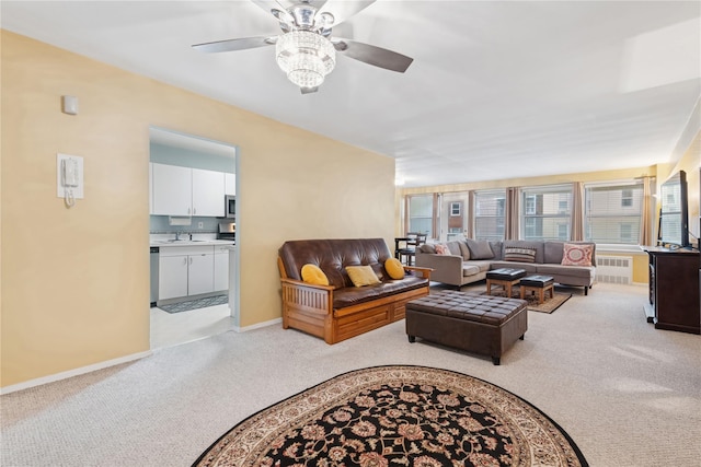 711 Shore Rd Unit 4F, Long Beach, NY 11561 - living room with light carpet, a ceiling fan, baseboards, and radiator heating unit