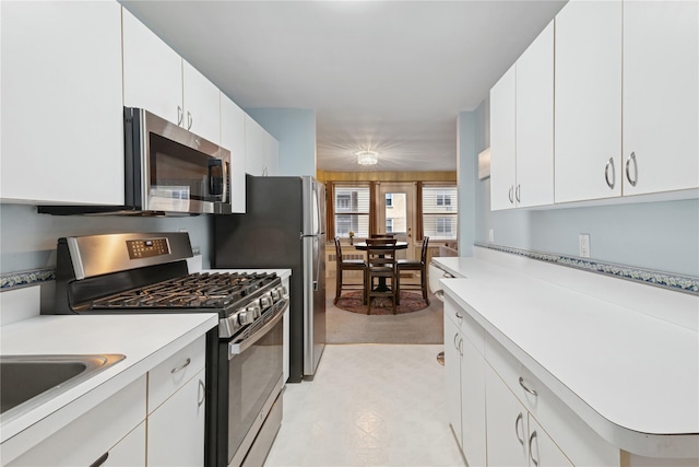 711 Shore Rd Unit 4F, Long Beach, NY 11561 - kitchen featuring stainless steel appliances, light countertops, white cabinetry, and a sink