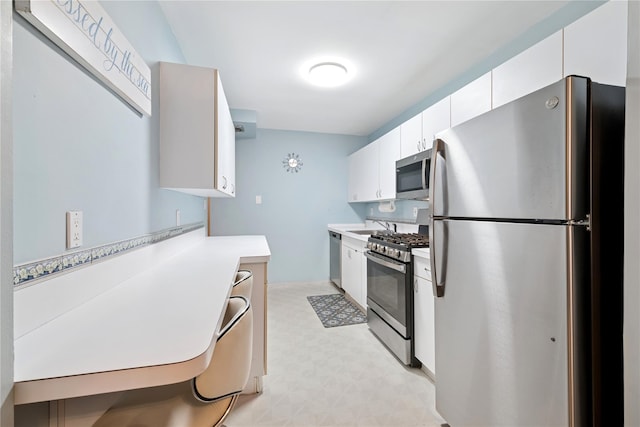 711 Shore Rd Unit 4F, Long Beach, NY 11561 - kitchen featuring appliances with stainless steel finishes, light floors, light countertops, white cabinets, and a sink