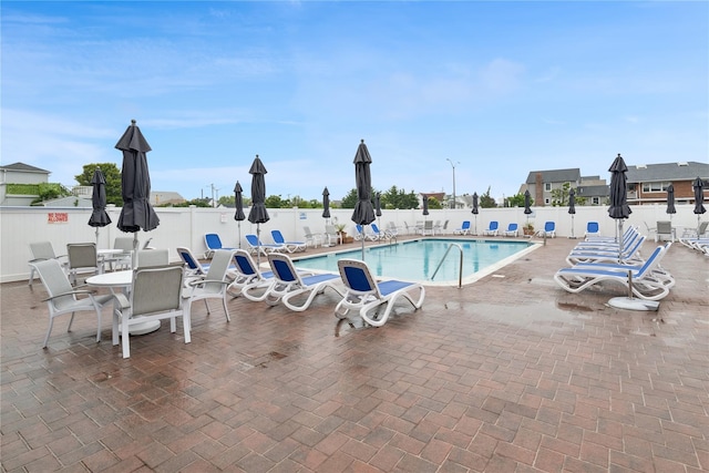 711 Shore Rd Unit 4F, Long Beach, NY 11561 - community pool with a fenced backyard and a patio