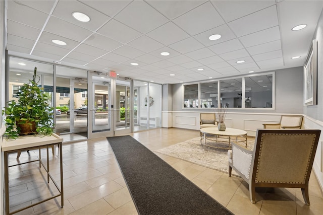 711 Shore Rd Unit 4F, Long Beach, NY 11561 - lobby featuring a drop ceiling and a wainscoted wall
