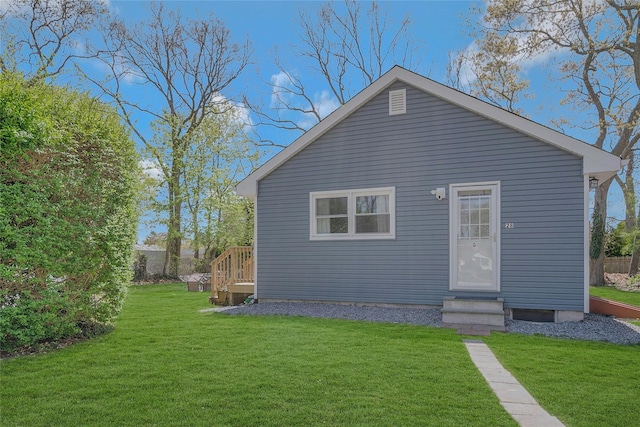 28 Lynncliff Rd, Hampton Bays, NY 11946 - rear view of property featuring entry steps and a lawn