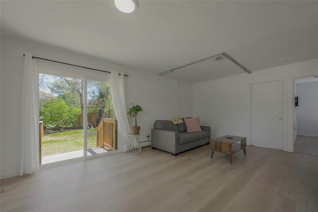 28 Lynncliff Rd, Hampton Bays, NY 11946 - living area featuring light wood finished floors and baseboard heating