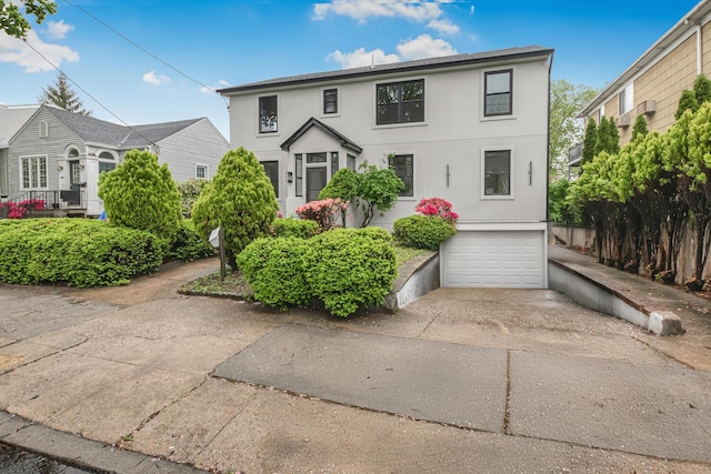 147 Florence St, Yonkers, NY 10704 - view of front of home featuring an attached garage, concrete driveway, and stucco siding