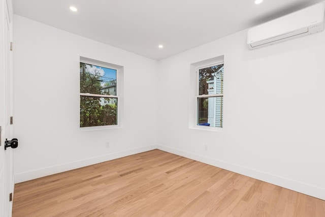 147 Florence St, Yonkers, NY 10704 - spare room featuring a wall mounted air conditioner, light wood-type flooring, baseboards, and recessed lighting