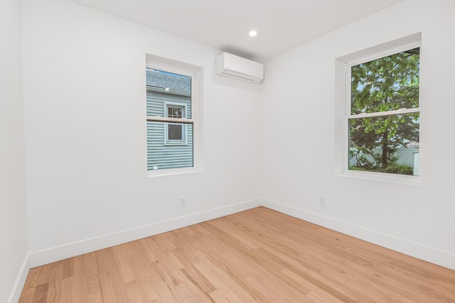 147 Florence St, Yonkers, NY 10704 - unfurnished room featuring baseboards, a wall mounted AC, light wood-type flooring, and recessed lighting