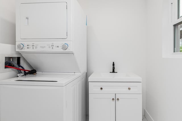 147 Florence St, Yonkers, NY 10704 - washroom featuring stacked washer / drying machine and cabinet space