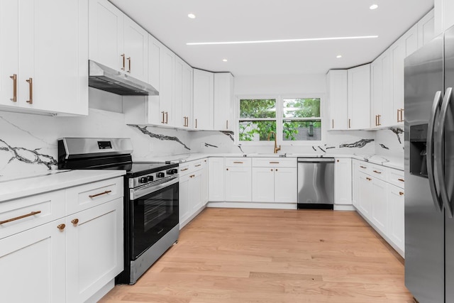 147 Florence St, Yonkers, NY 10704 - kitchen featuring appliances with stainless steel finishes, under cabinet range hood, white cabinets, and recessed lighting