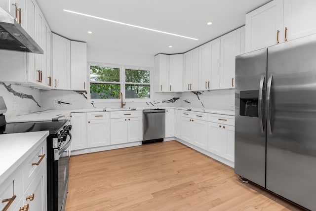 147 Florence St, Yonkers, NY 10704 - kitchen featuring appliances with stainless steel finishes, extractor fan, a sink, white cabinetry, and recessed lighting