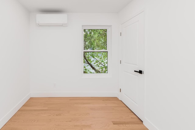 147 Florence St, Yonkers, NY 10704 - empty room with a wall mounted air conditioner, baseboards, and light wood-style flooring