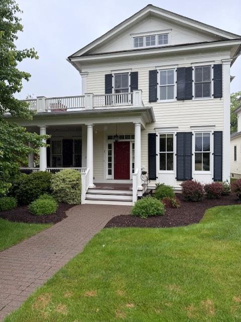1 Sly St, Warwick, NY 10990 - neoclassical home with a balcony, a front lawn, and a porch