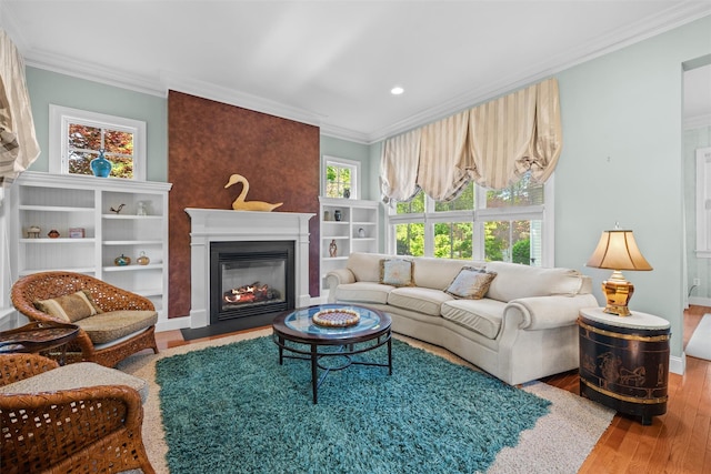 1 Sly St, Warwick, NY 10990 - living area with ornamental molding, a glass covered fireplace, wood finished floors, and recessed lighting