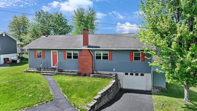 view of front of house featuring a chimney, driveway, an attached garage, and a front lawn