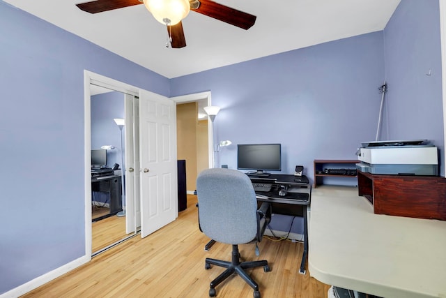 office space featuring wood finished floors, ceiling fan, and baseboards