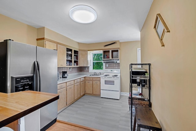 kitchen with white range with electric cooktop, stainless steel fridge, light brown cabinets, open shelves, and a sink