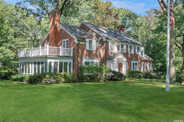 3 Barkers Point Rd, Sands Point, NY 11050 - view of front facade with a chimney, a balcony, and a front lawn