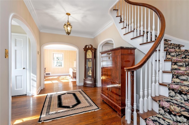 3 Barkers Point Rd, Sands Point, NY 11050 - entrance foyer featuring arched walkways, ornamental molding, hardwood / wood-style flooring, stairway, and baseboards