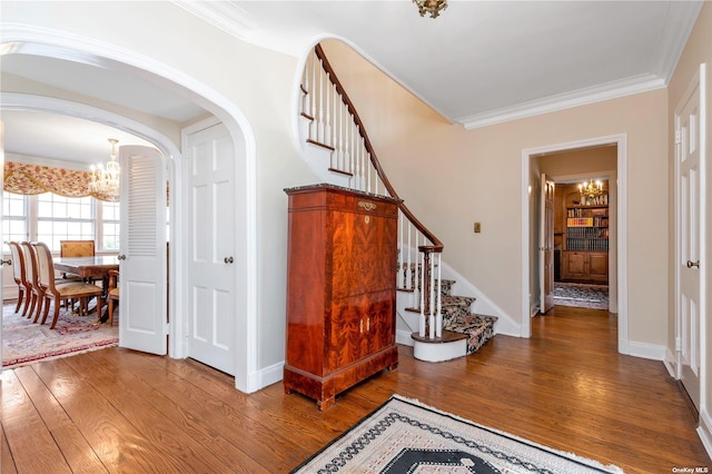 3 Barkers Point Rd, Sands Point, NY 11050 - foyer with a chandelier, stairs, wood finished floors, crown molding, and arched walkways