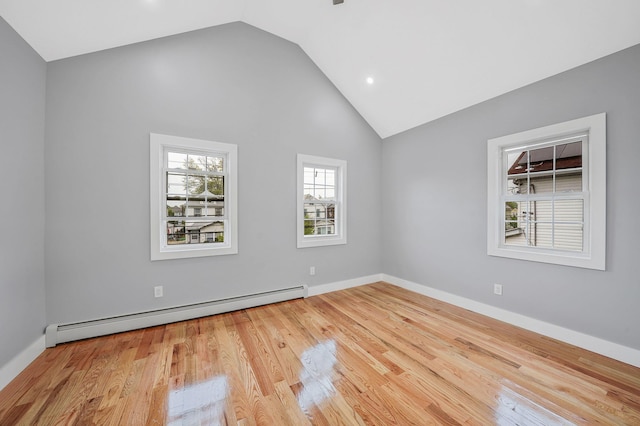 11827 219th St, Cambria Heights, NY 11411 - spare room with a baseboard heating unit, wood finished floors, recessed lighting, baseboards, and high vaulted ceiling
