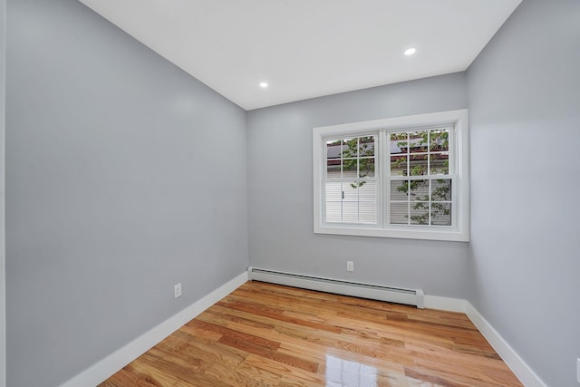 11827 219th St, Cambria Heights, NY 11411 - spare room with baseboard heating, baseboards, wood finished floors, and recessed lighting