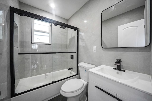 11827 219th St, Cambria Heights, NY 11411 - bathroom with toilet, bath / shower combo with glass door, vanity, and tile walls