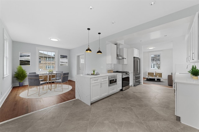 kitchen with stainless steel appliances, plenty of natural light, light countertops, and white cabinetry