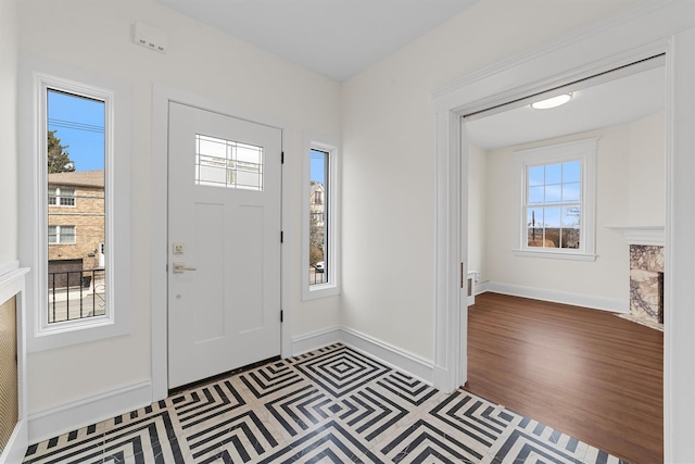 entrance foyer featuring plenty of natural light, baseboards, and wood finished floors