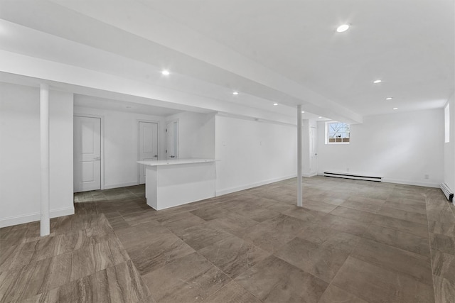 below grade area with a baseboard heating unit, recessed lighting, and baseboards