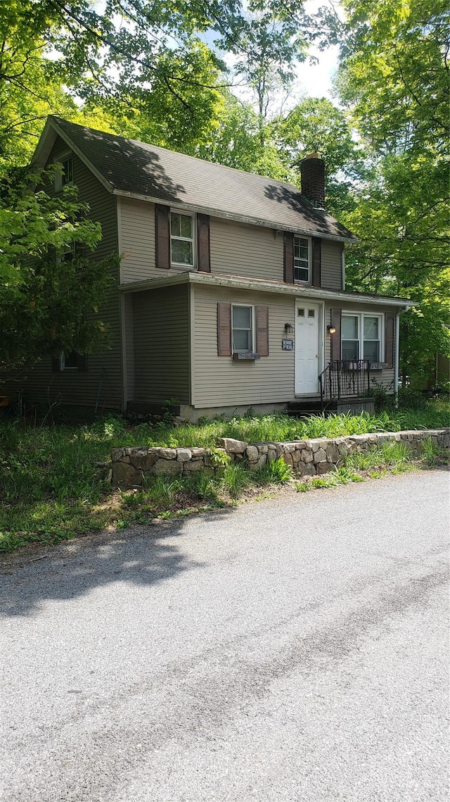 14 SE Mountain Rd, Wingdale, NY 12594 - view of front facade with a chimney and a porch
