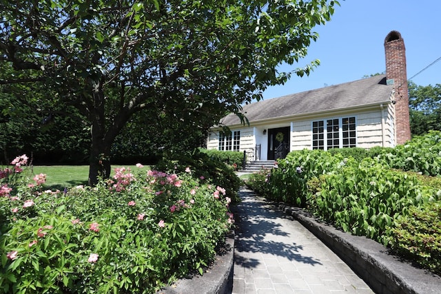 8 Hazel Rd, Port Washington, NY 11050 - view of front of home with a chimney