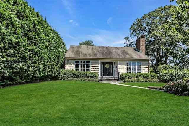 8 Hazel Rd, Port Washington, NY 11050 - view of front of home with a front yard, a chimney, and a shingled roof