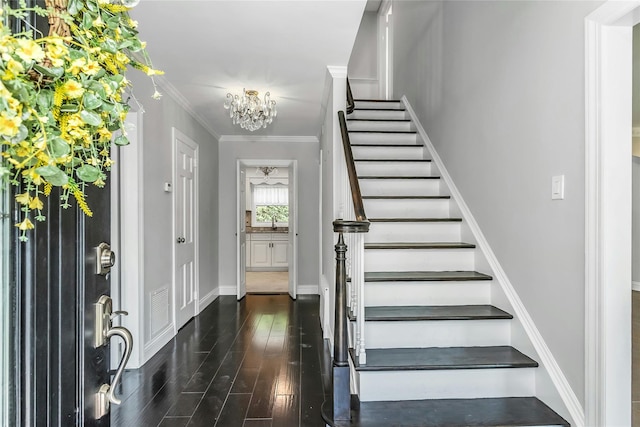 8 Hazel Rd, Port Washington, NY 11050 - entryway with stairs, wood finished floors, a chandelier, and ornamental molding