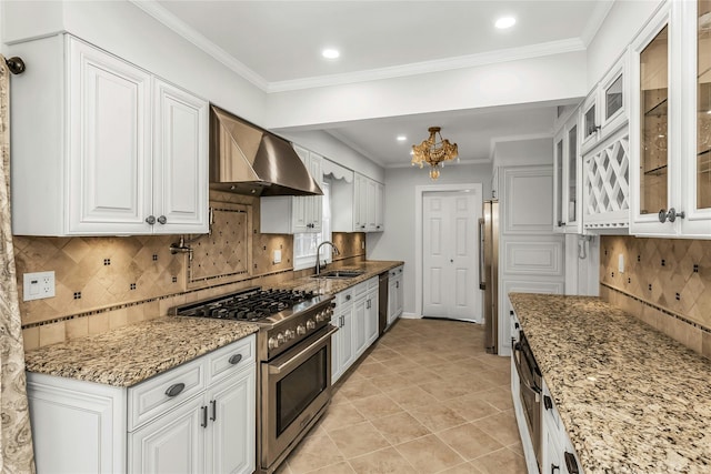 8 Hazel Rd, Port Washington, NY 11050 - kitchen with appliances with stainless steel finishes, wall chimney range hood, white cabinets, backsplash, and light stone countertops