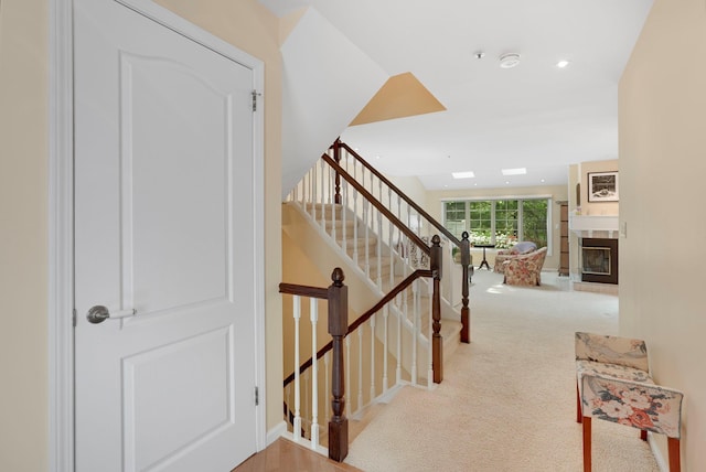 48 Clarewood Dr, Hastings-On-Hudson, NY 10706 - staircase featuring a fireplace, carpet floors, and recessed lighting
