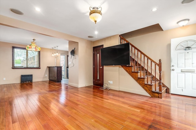 67-15 Bell Blvd Duplex, Unit Duplex, Bayside, NY 11364 - unfurnished living room with radiator, light wood finished floors, stairway, baseboards, and a chandelier