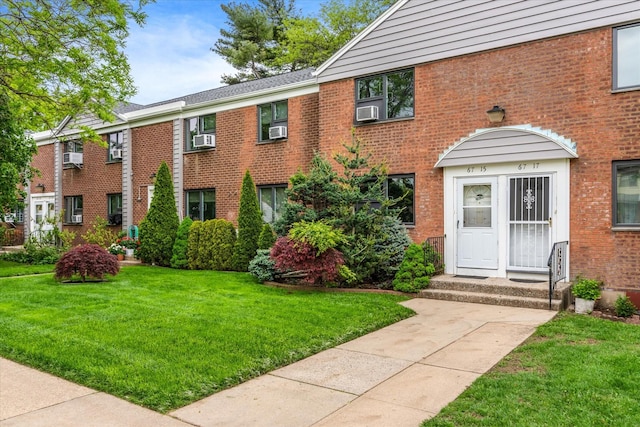 67-15 Bell Blvd Duplex, Unit Duplex, Bayside, NY 11364 - view of property featuring brick siding, a front lawn, and cooling unit