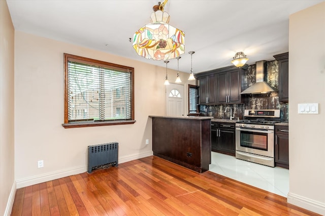 67-15 Bell Blvd Duplex, Unit Duplex, Bayside, NY 11364 - kitchen with gas stove, wall chimney exhaust hood, radiator, decorative backsplash, and light wood-type flooring