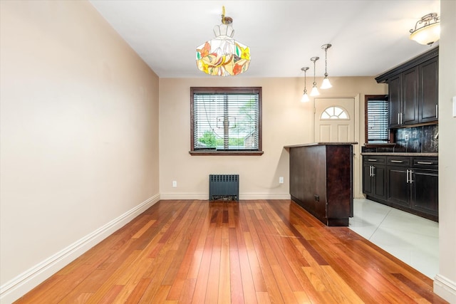 67-15 Bell Blvd Duplex, Unit Duplex, Bayside, NY 11364 - kitchen with baseboards, backsplash, light wood finished floors, pendant lighting, and radiator