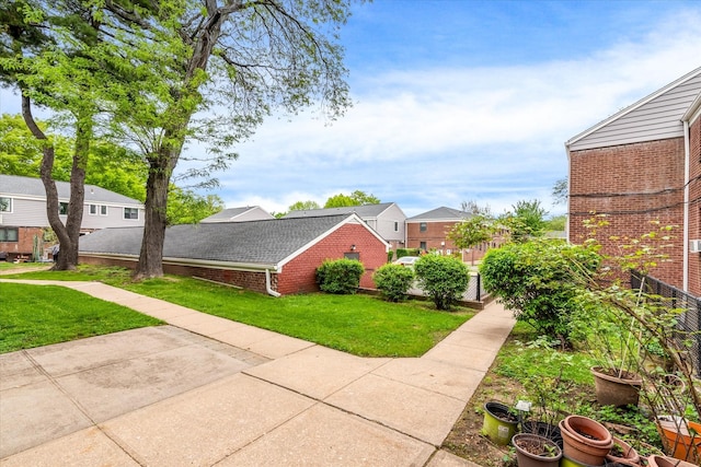 67-15 Bell Blvd Duplex, Unit Duplex, Bayside, NY 11364 - view of home's exterior with brick siding, a lawn, and a residential view
