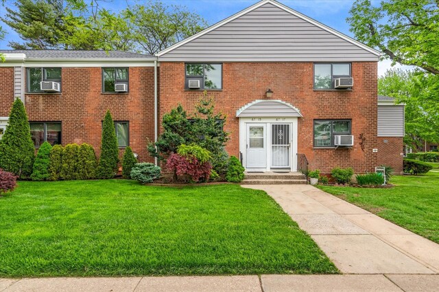 67-15 Bell Blvd Duplex, Unit Duplex, Bayside, NY 11364 - view of front of home featuring a front lawn, brick siding, and cooling unit