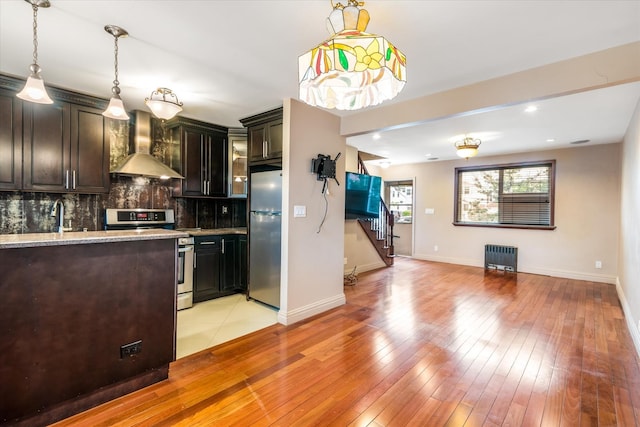 67-15 Bell Blvd Duplex, Unit Duplex, Bayside, NY 11364 - kitchen with wall chimney exhaust hood, stainless steel appliances, radiator, decorative backsplash, and baseboards