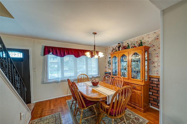 86 Vincent Rd, Hicksville, NY 11801 - dining area featuring a chandelier, stairway, wood finished floors, and baseboards