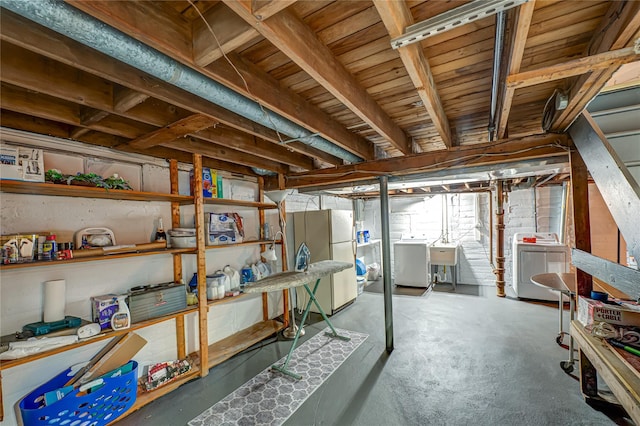 86 Vincent Rd, Hicksville, NY 11801 - basement featuring washer and clothes dryer, freestanding refrigerator, and a sink