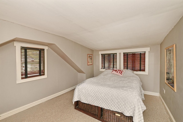 bedroom featuring carpet flooring, baseboards, and vaulted ceiling